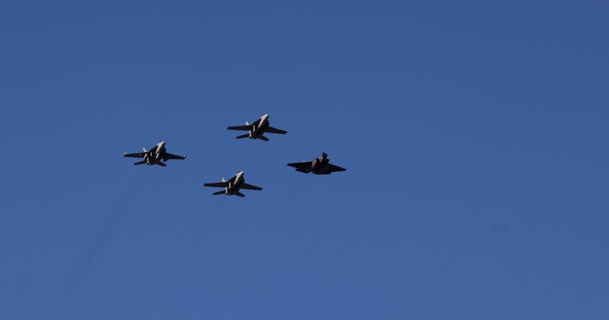 Four planes are flying in a diamond formation in the sky