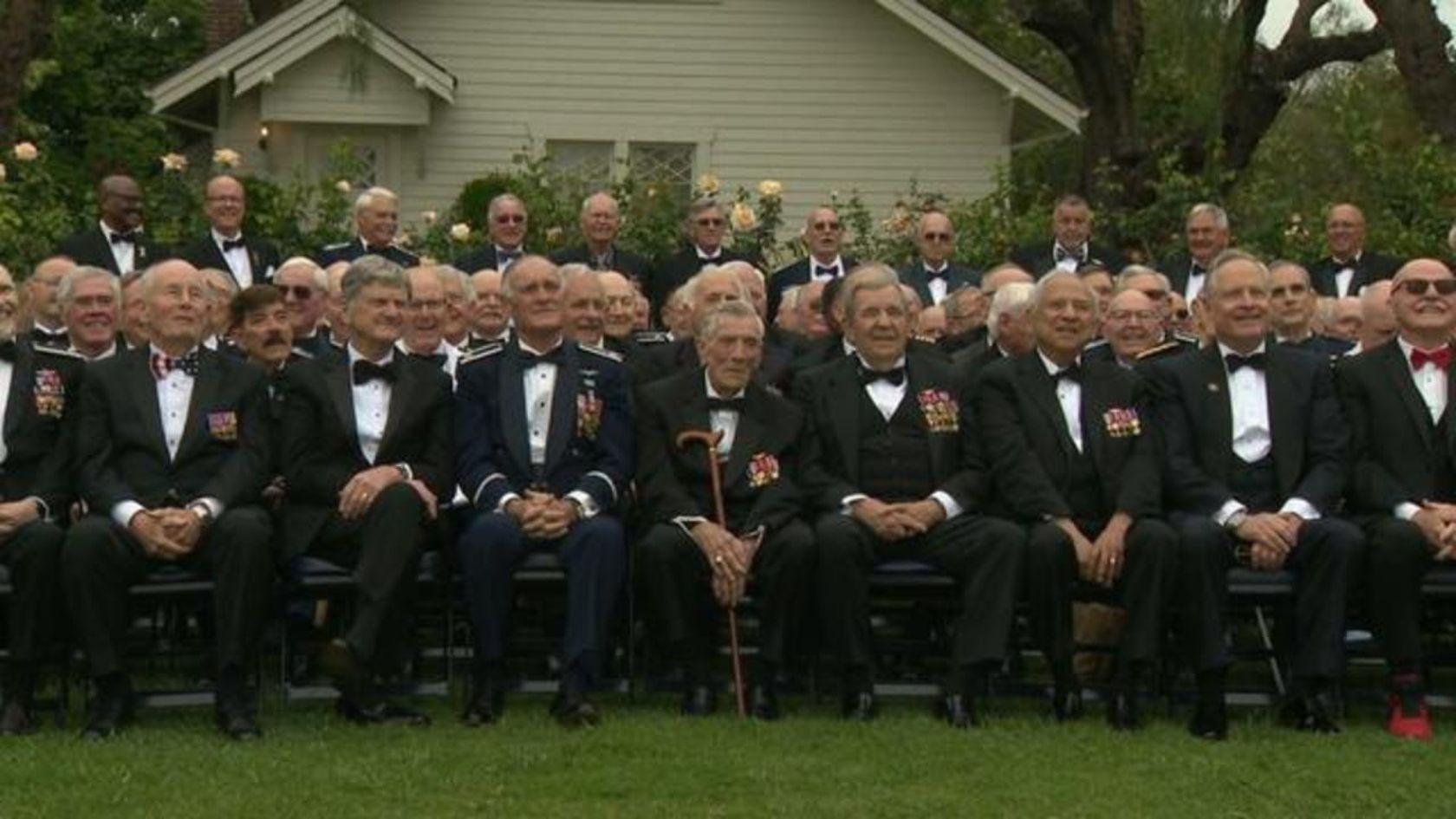men in uniform sitting on chairs