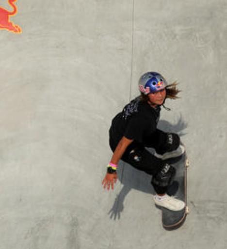 A young girl on a skateboard in skate park