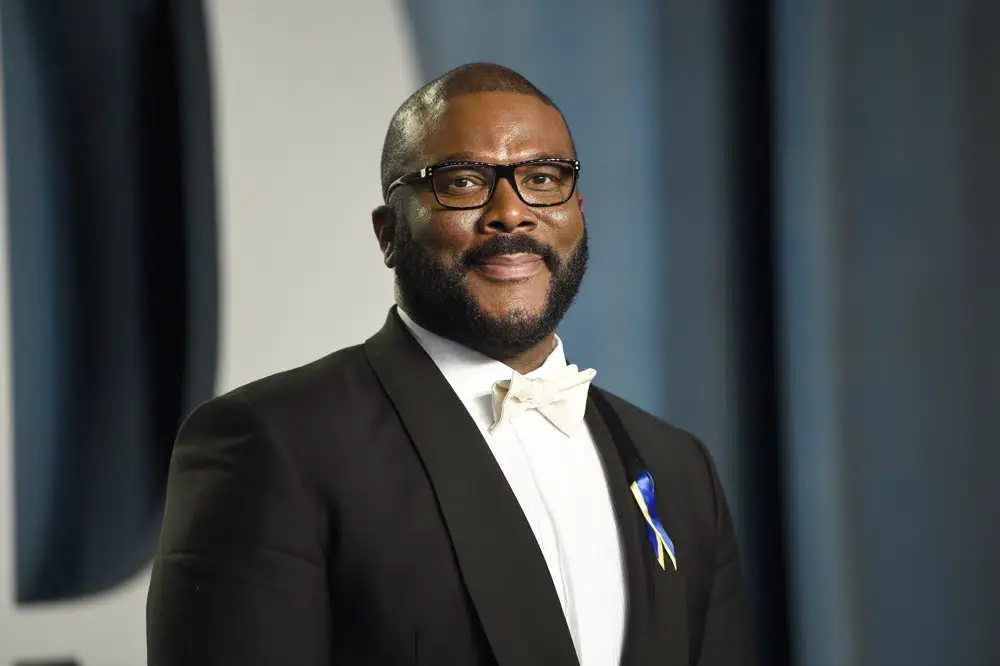Tyler Perry arrives at the Vanity Fair Oscar Party in Beverly Hills, Calif., on March 27, 2022. He is wearing a black suit with a white dress shirt.